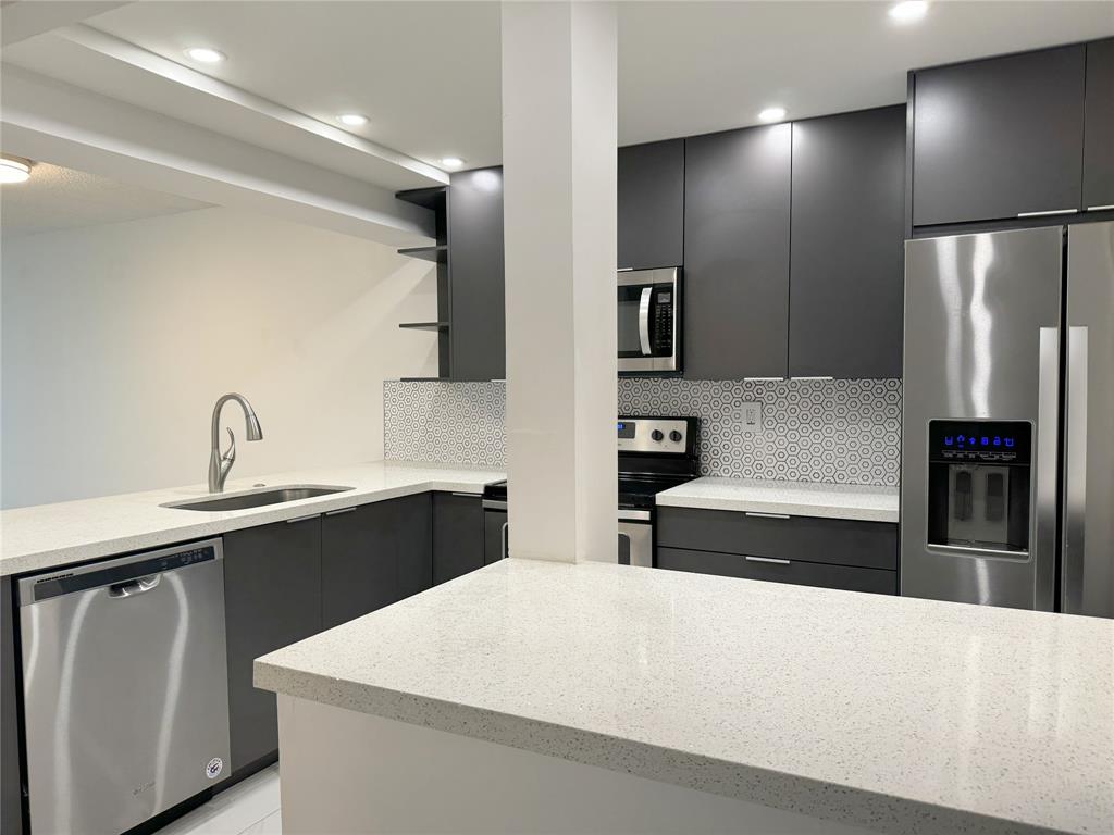 6800 Cypress Road, Unit 102 Plantation, FL 33317 - Photo 11 of 29 a large kitchen with stainless steel appliances a refrigerator and a sink