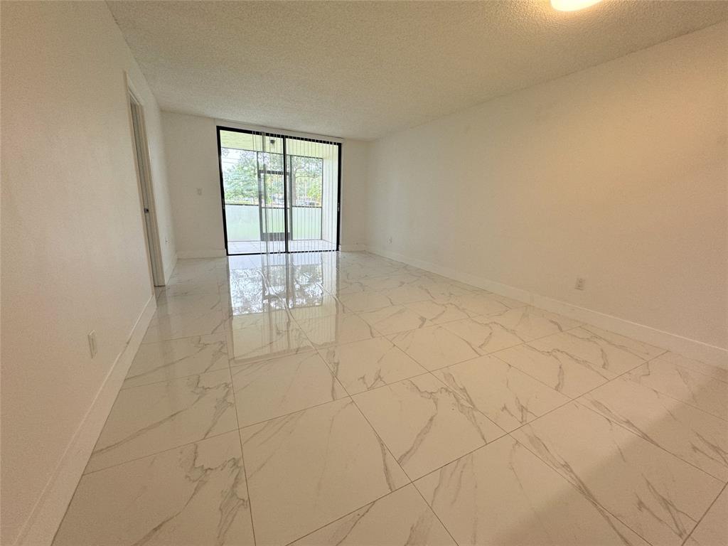 6800 Cypress Road, Unit 102 Plantation, FL 33317 - Photo 12 of 29 a view of an empty room and window