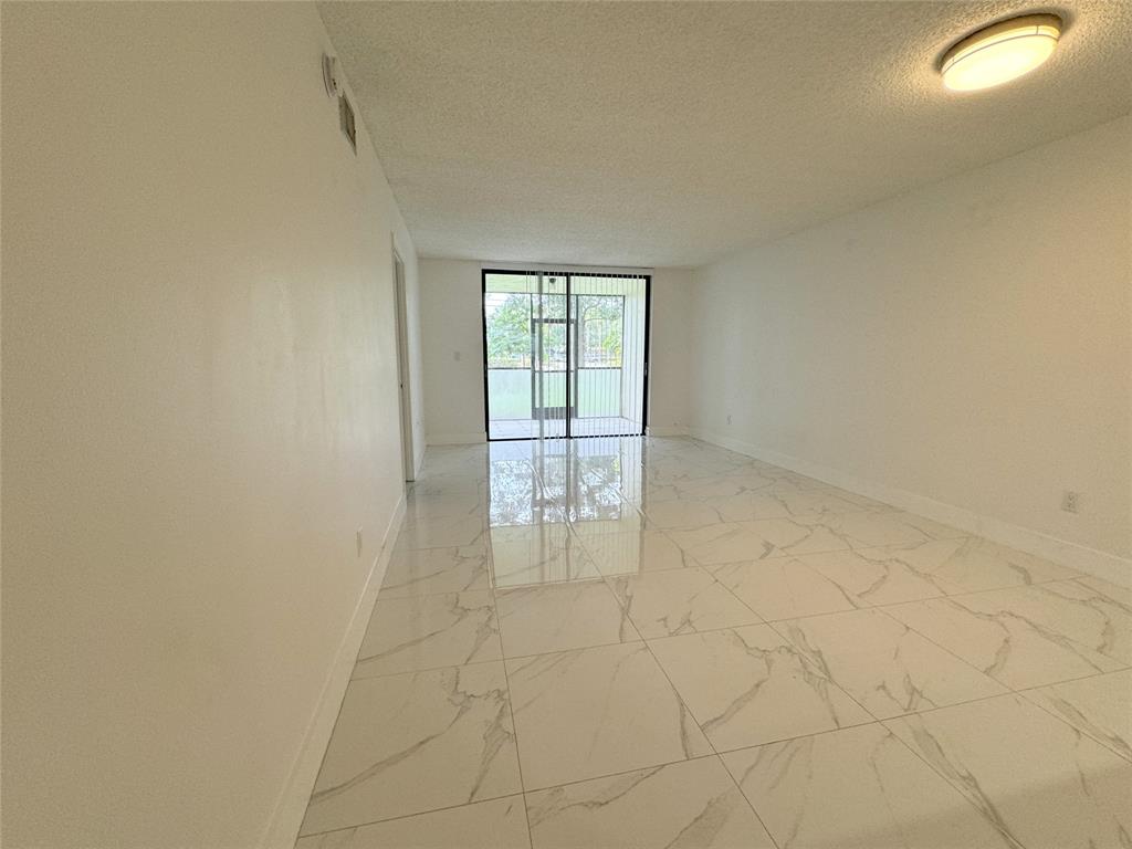 6800 Cypress Road, Unit 102 Plantation, FL 33317 - Photo 13 of 29 a view of an empty room and window