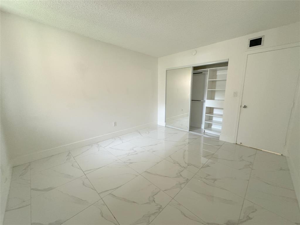 6800 Cypress Road, Unit 102 Plantation, FL 33317 - Photo 16 of 29 an empty room with a empty space