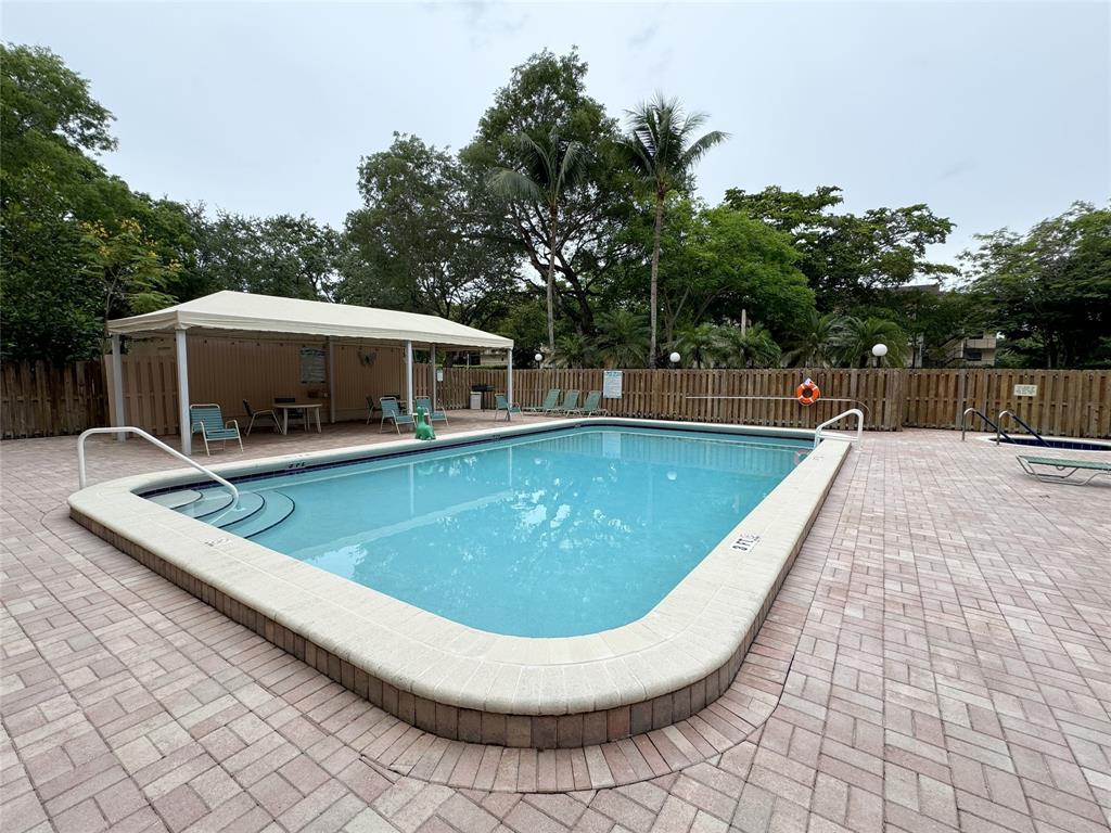 6800 Cypress Road, Unit 102 Plantation, FL 33317 - Photo 24 of 29 a view of a swimming pool with lounge chair