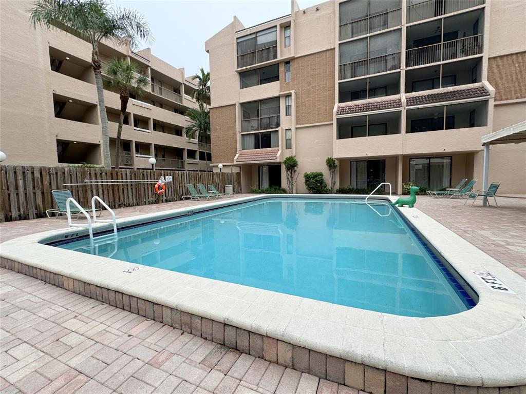 6800 Cypress Road, Unit 102 Plantation, FL 33317 - Photo 25 of 29 a view of building with swimming pool and sitting space
