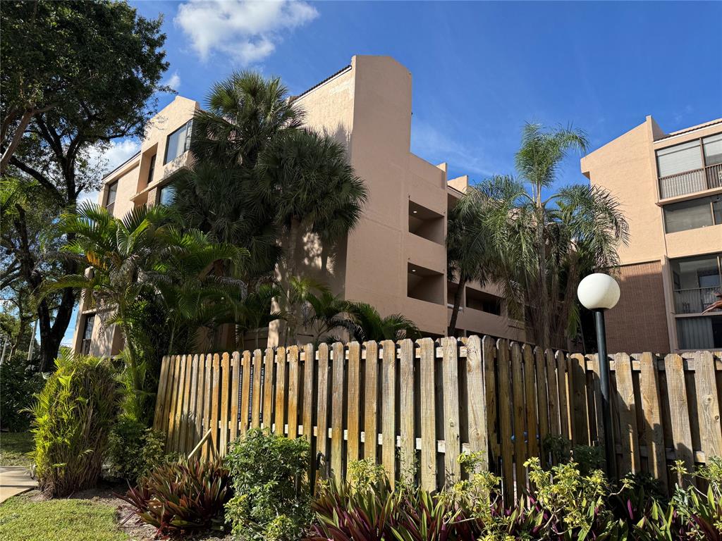 6800 Cypress Road, Unit 102 Plantation, FL 33317 - Photo 29 of 29 a front view of a house with a garden