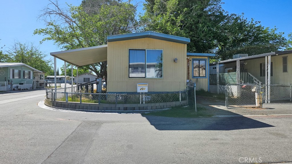45800 Challenger Way, Unit 251 Lancaster, CA 93535 - Photo 1 of 7 a front view of a house with garden