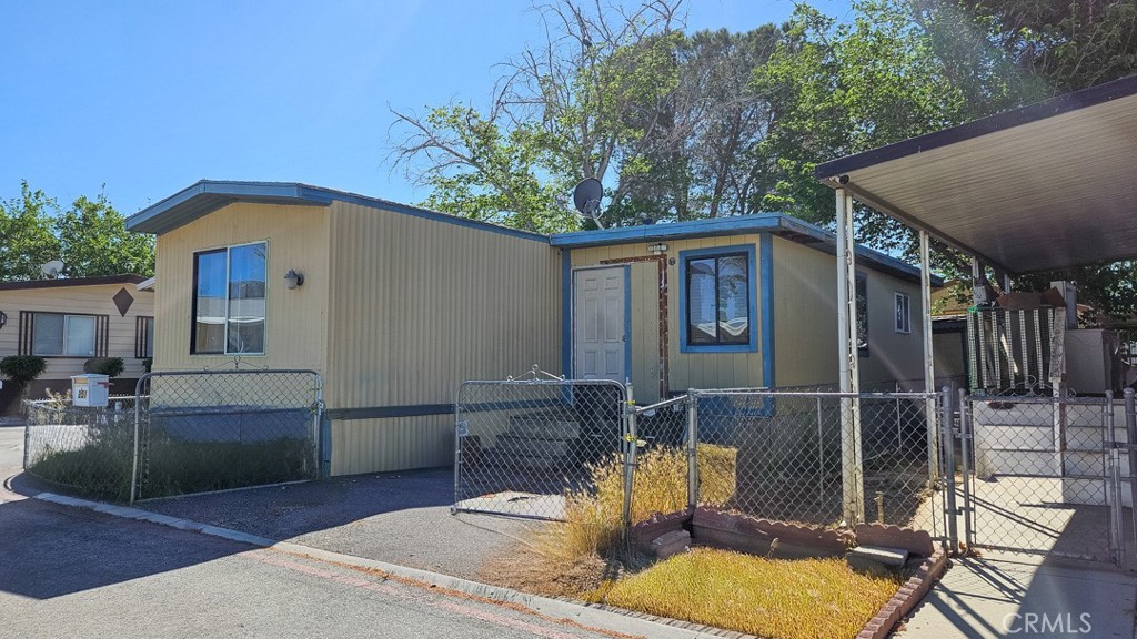 45800 Challenger Way, Unit 251 Lancaster, CA 93535 - Photo 2 of 7 a front view of a house with garden