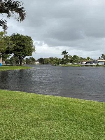 a view of a lake with houses in the back