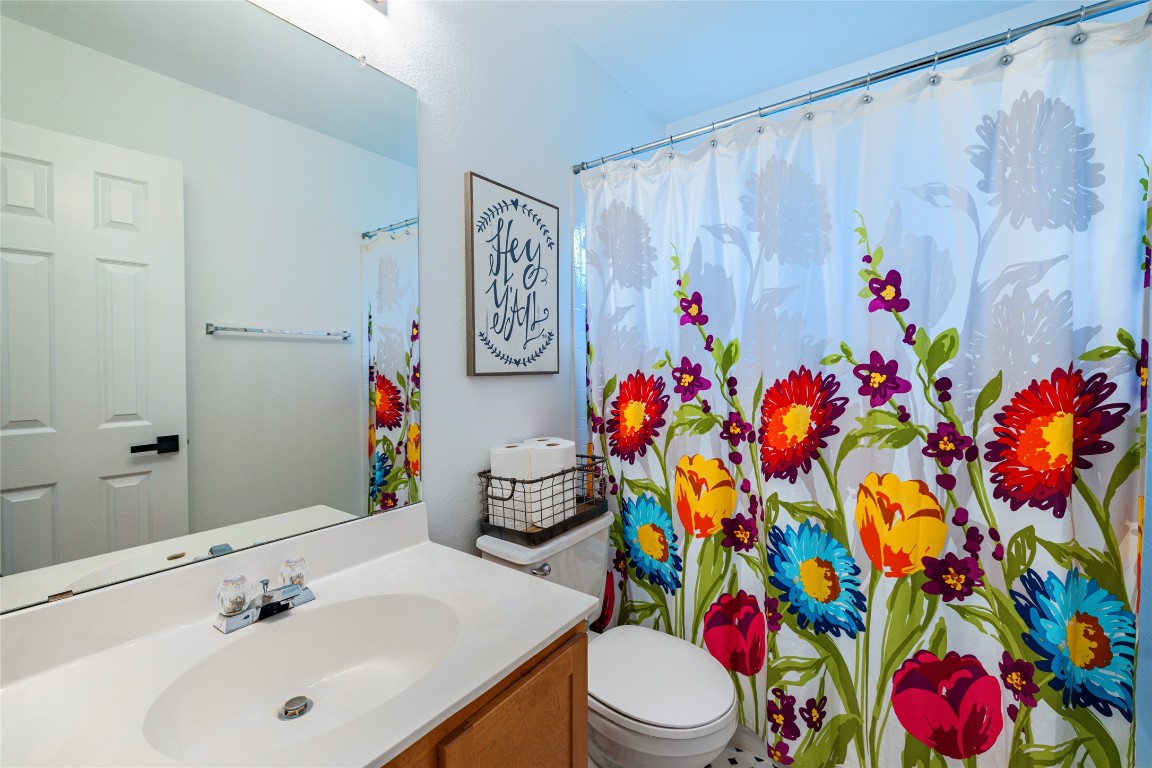 1130 Sundrop Place Round Rock, TX 78665 - Photo 14 of 19 a bathroom with a sink mirror vanity and toilet