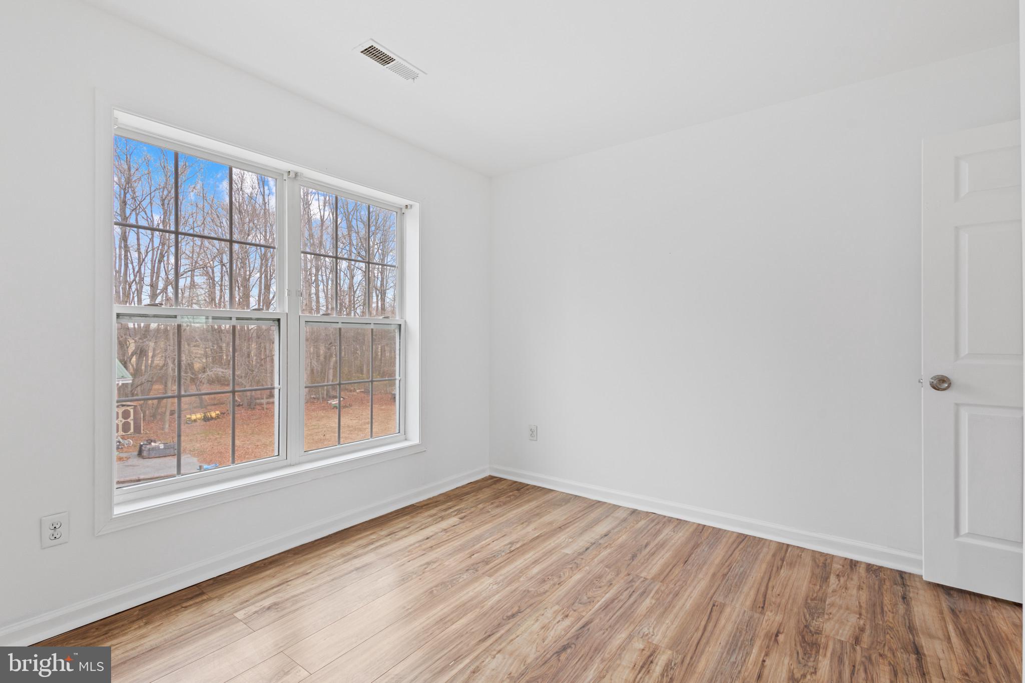 125 Oliver Guessford Road Townsend, DE 19734 - Photo 28 of 48 a view of an empty room with wooden floor and a window