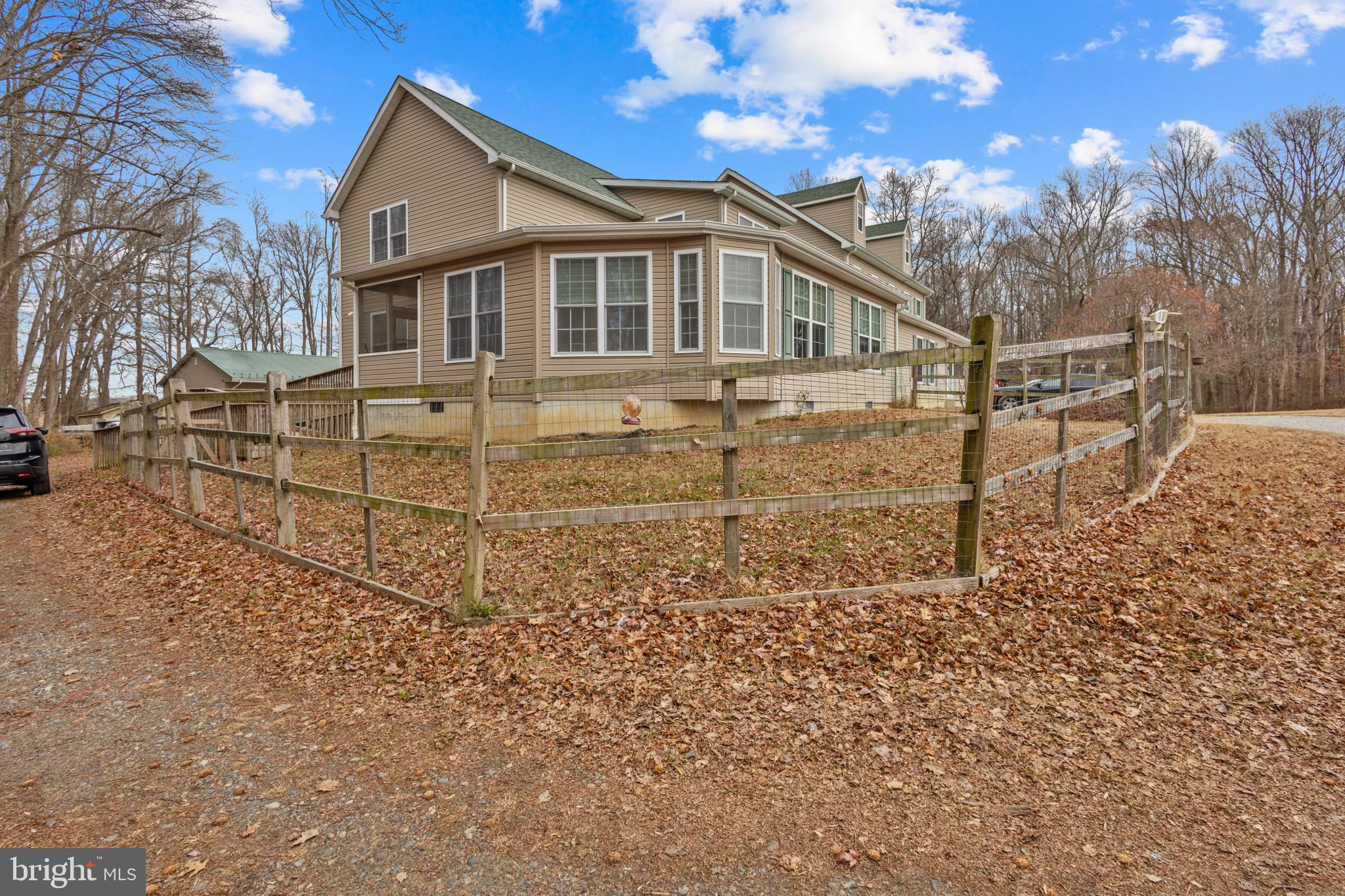 125 Oliver Guessford Road Townsend, DE 19734 - Photo 29 of 48 a view of a white house next to a yard with large trees