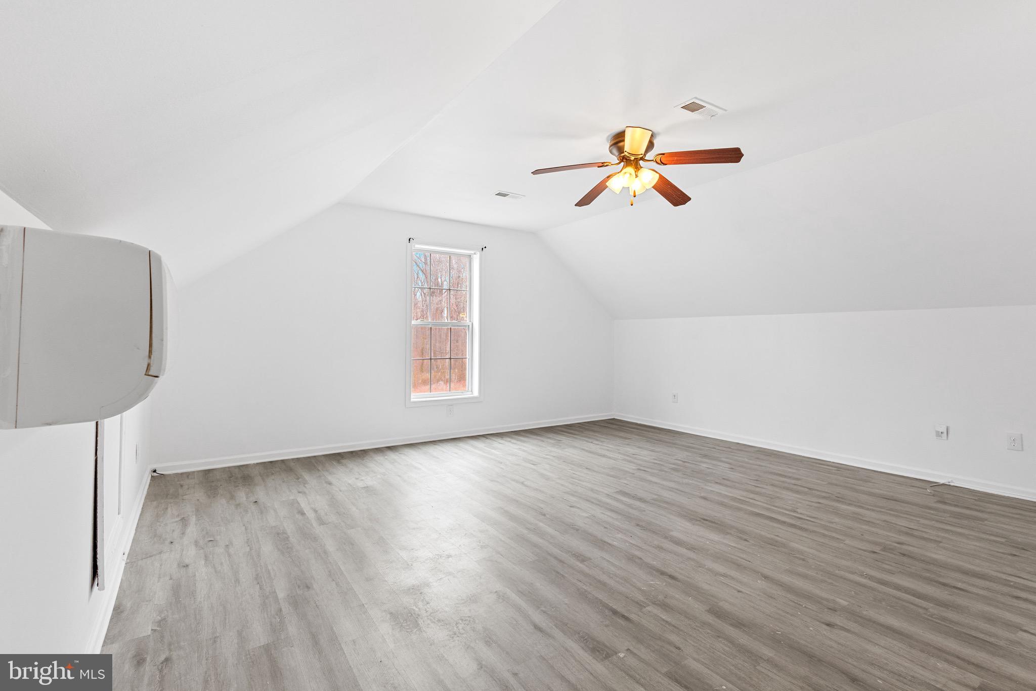 125 Oliver Guessford Road Townsend, DE 19734 - Photo 41 of 48 an empty room with wooden floor and white walls