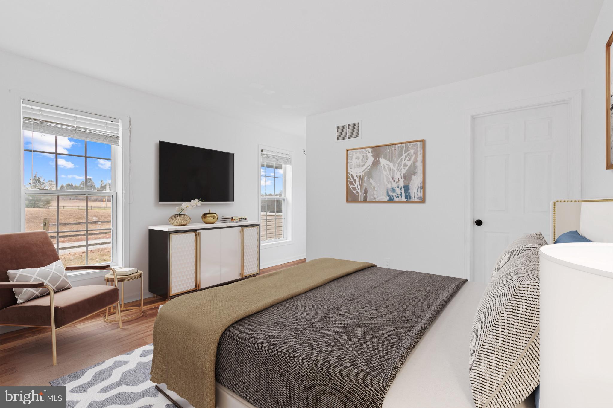 125 Oliver Guessford Road Townsend, DE 19734 - Photo 5 of 48 a bedroom with a bed and a flat screen tv