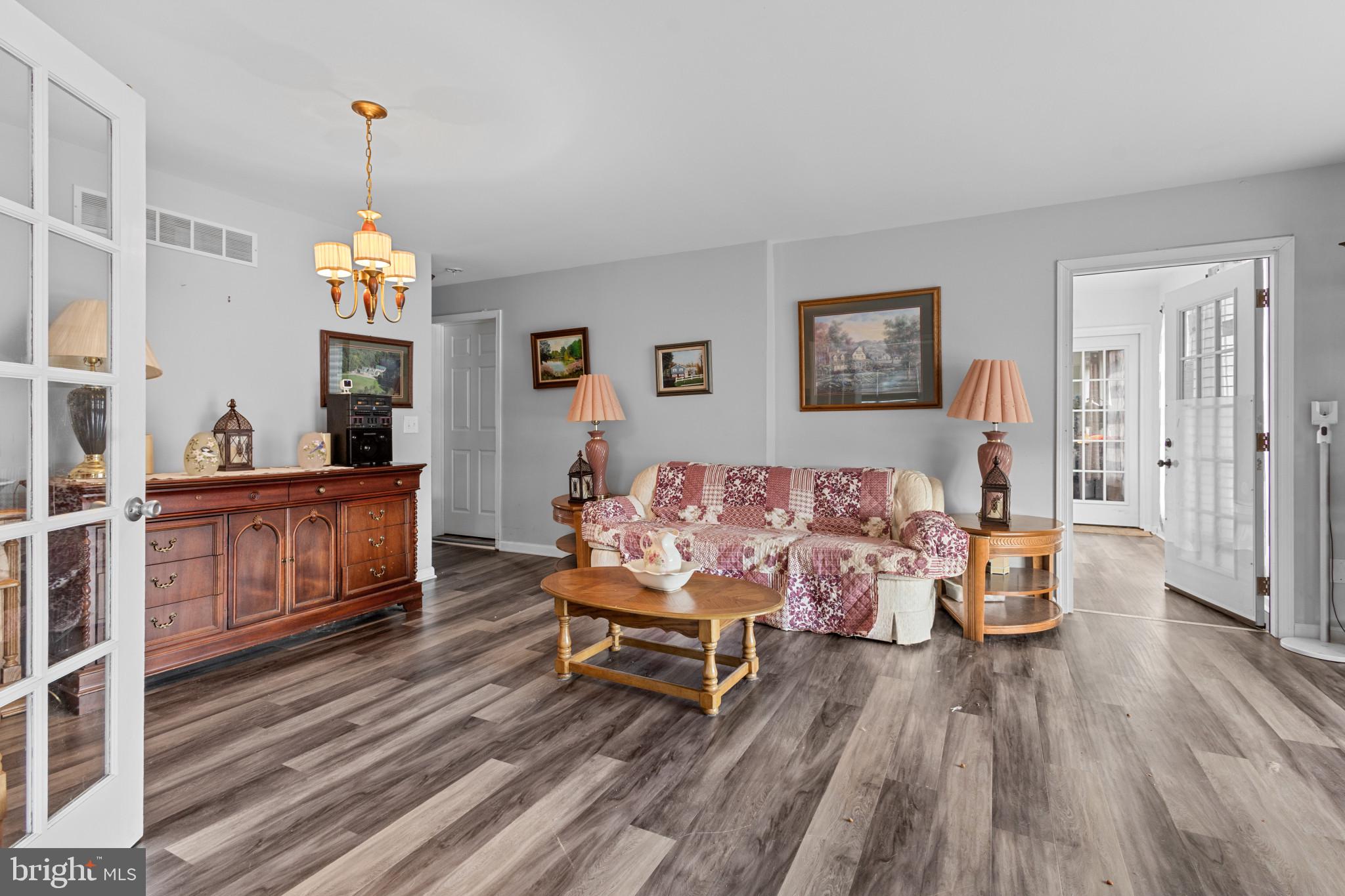 125 Oliver Guessford Road Townsend, DE 19734 - Photo 8 of 48 a living room with furniture and wooden floor