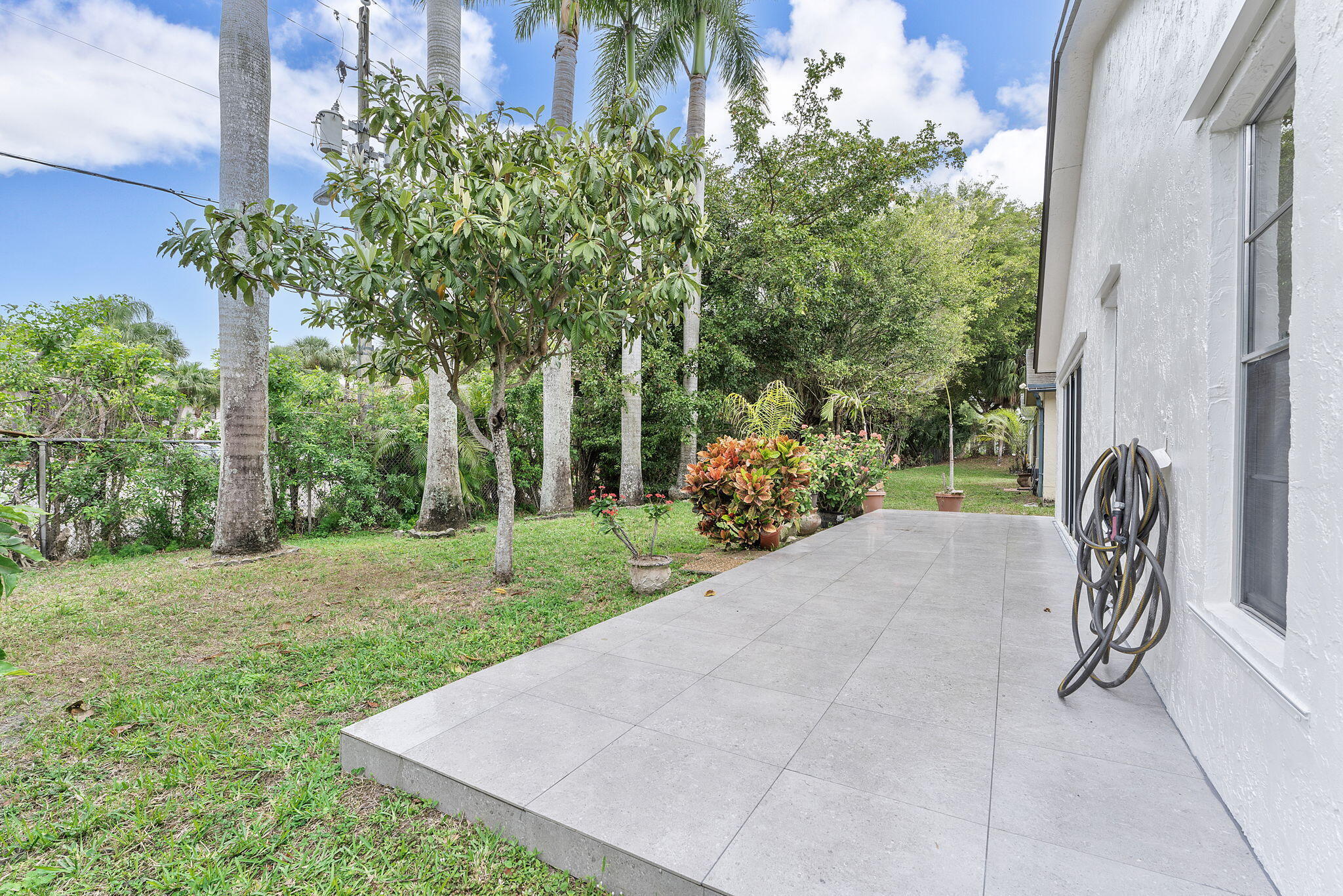 9180 Pine Springs Drive Boca Raton, FL 33428 - Photo 25 of 29 a view of a backyard with plants and a patio