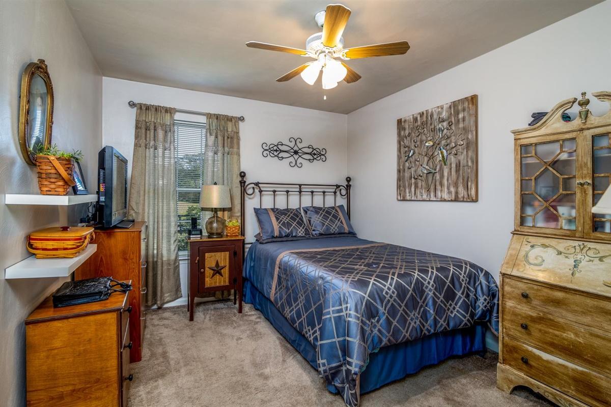 1849 Morgans Mill Road Goodview, VA 24095 - Photo 14 of 40 a bedroom with a bed and a chandelier