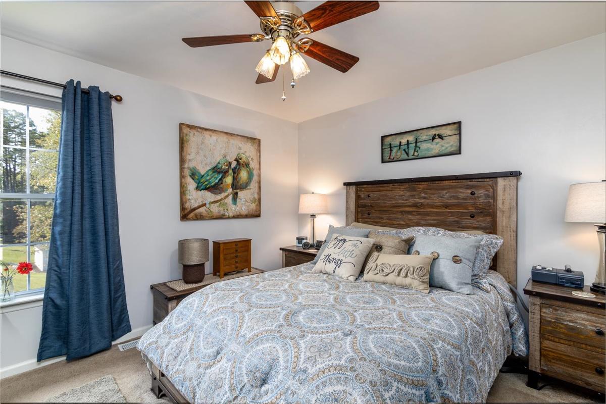 1849 Morgans Mill Road Goodview, VA 24095 - Photo 16 of 40 a bedroom with a large bed and a window
