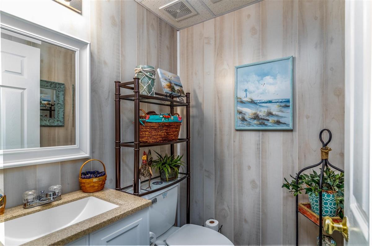 1849 Morgans Mill Road Goodview, VA 24095 - Photo 21 of 40 a bathroom with a toilet a sink and a window