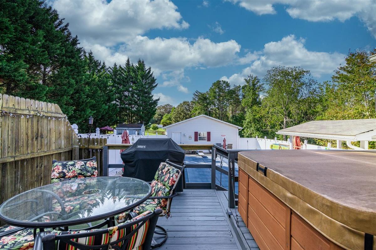 1849 Morgans Mill Road Goodview, VA 24095 - Photo 26 of 40 a view of a patio with table and chairs with wooden floor and fence
