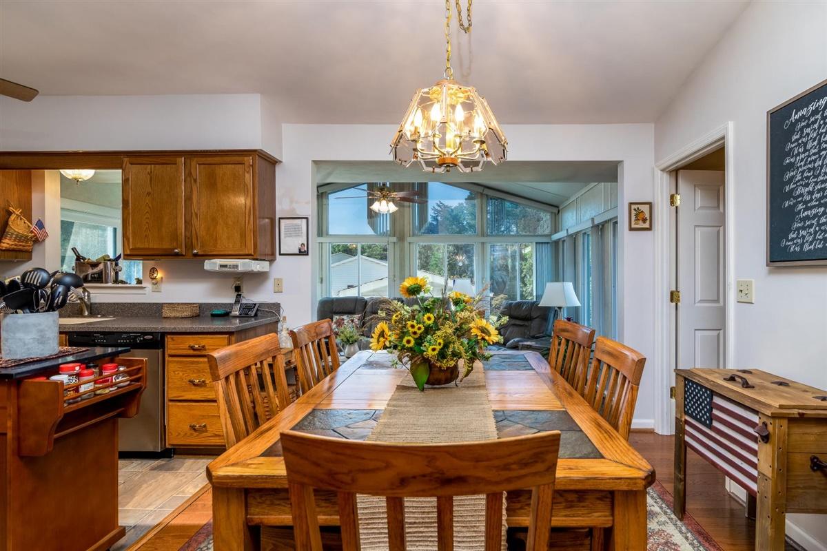 1849 Morgans Mill Road Goodview, VA 24095 - Photo 7 of 40 a view of a dining room with furniture and chandelier