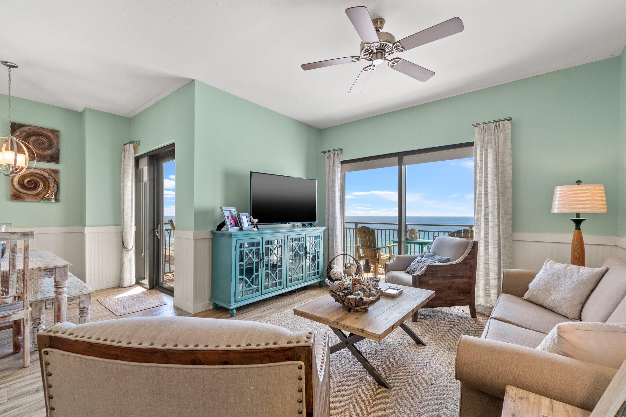 15100 Front Beach Road, Unit 1302 Panama City Beach, FL 32413 - Photo 19 of 67 a living room with furniture a flat screen tv and a large window