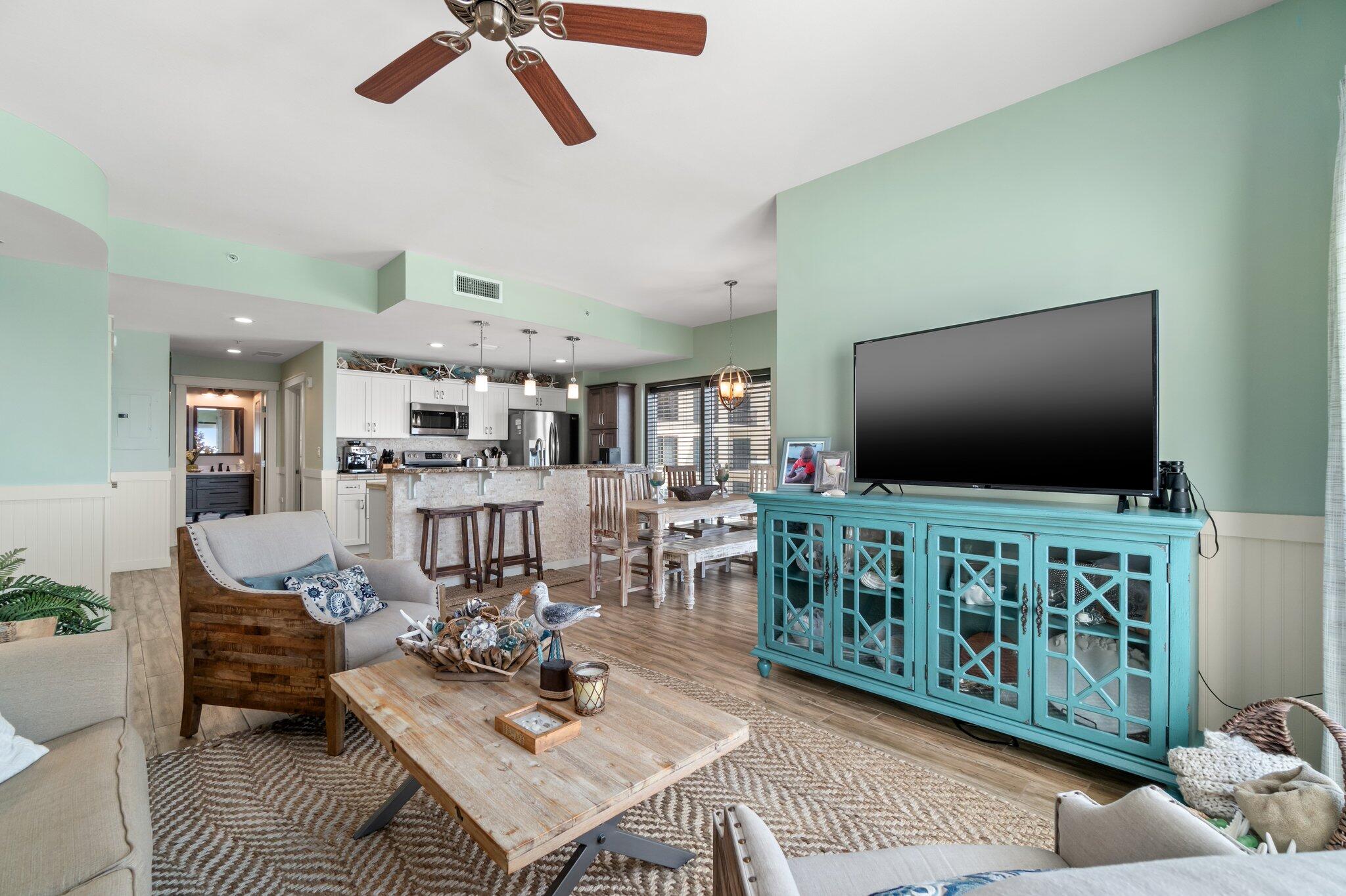 15100 Front Beach Road, Unit 1302 Panama City Beach, FL 32413 - Photo 23 of 67 a living room with furniture and a flat screen tv