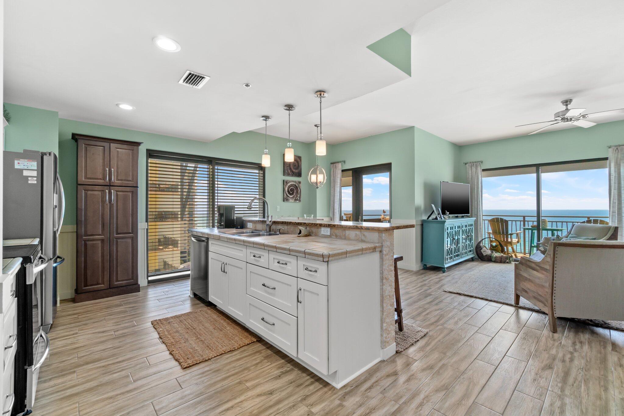 15100 Front Beach Road, Unit 1302 Panama City Beach, FL 32413 - Photo 24 of 67 a large kitchen with granite countertop a large counter top appliances and cabinets