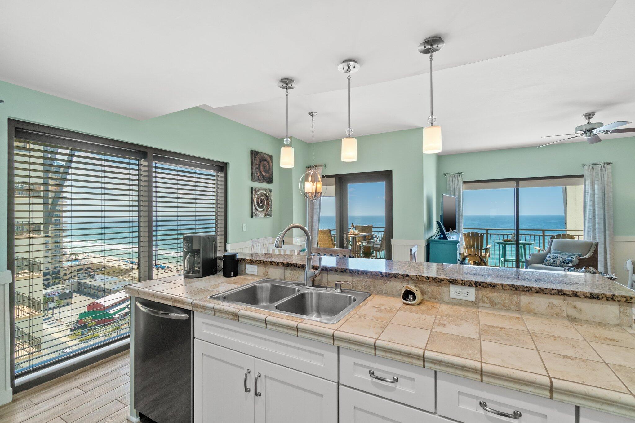 15100 Front Beach Road, Unit 1302 Panama City Beach, FL 32413 - Photo 25 of 67 a kitchen with counter top space a sink and appliances