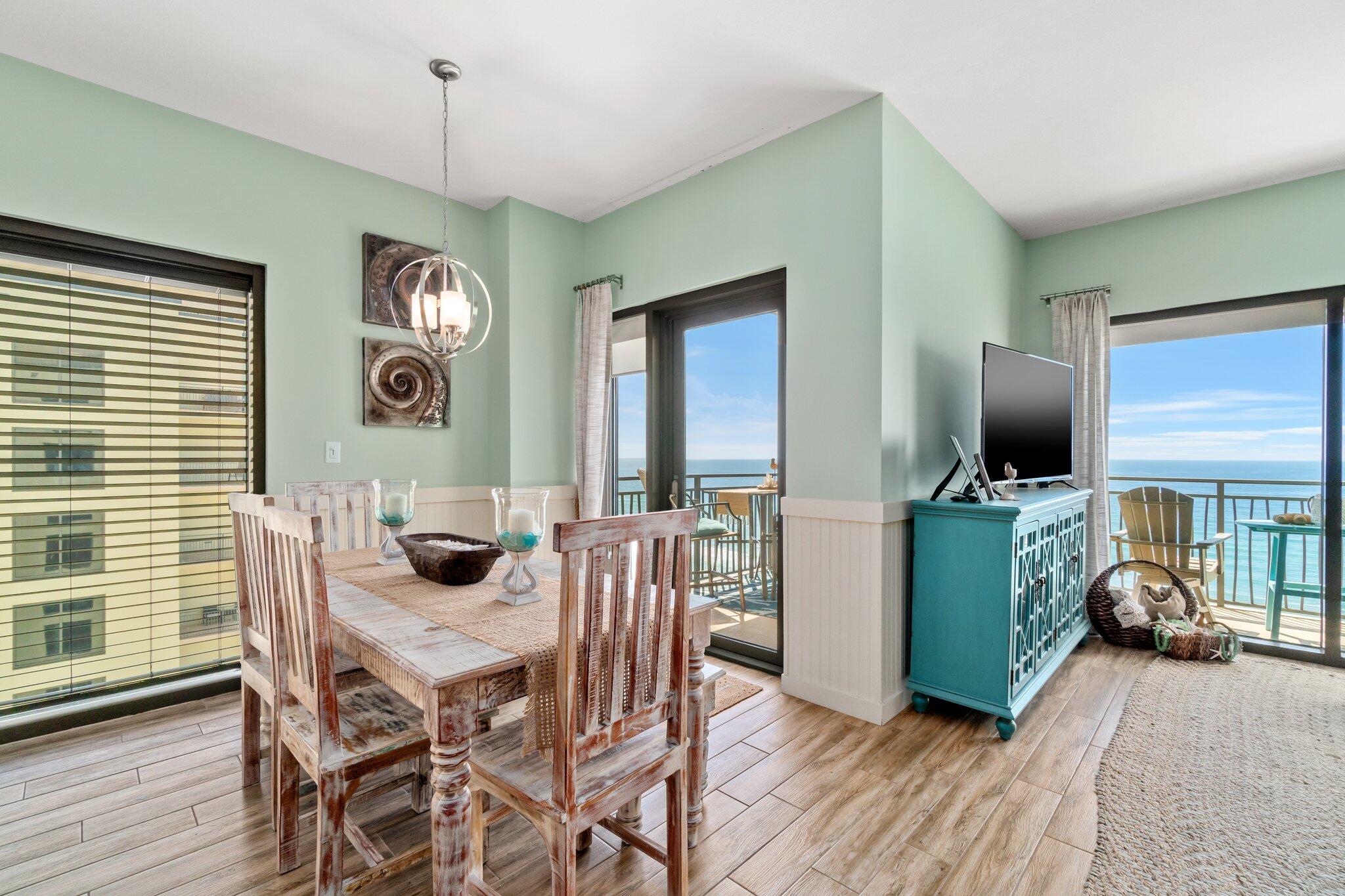 15100 Front Beach Road, Unit 1302 Panama City Beach, FL 32413 - Photo 28 of 67 a view of a dining room with furniture window and wooden floor