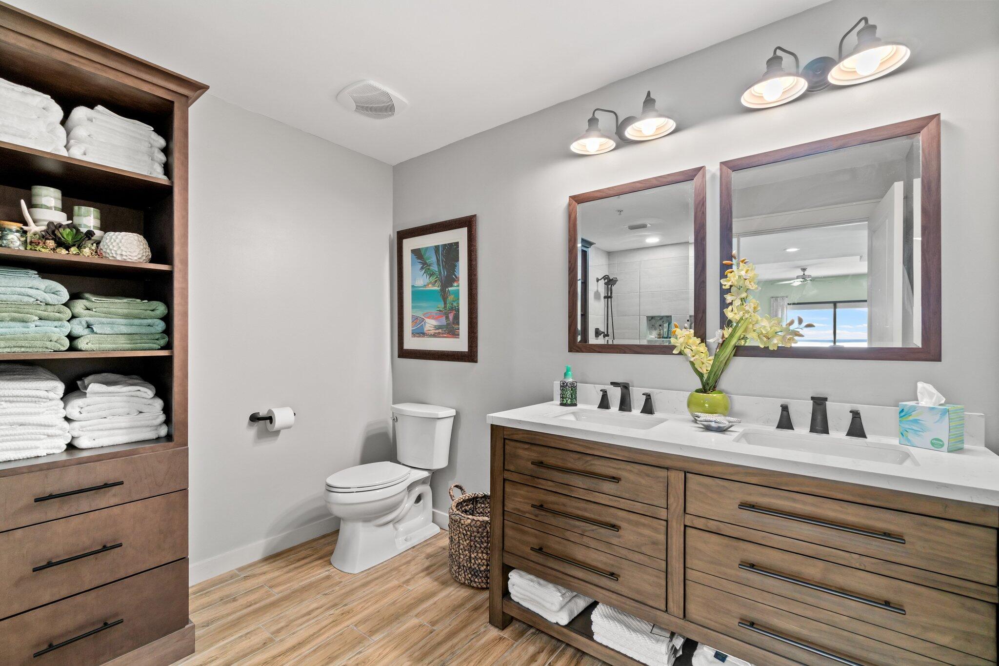 15100 Front Beach Road, Unit 1302 Panama City Beach, FL 32413 - Photo 31 of 67 a bathroom with a double vanity sink toilet and a mirror