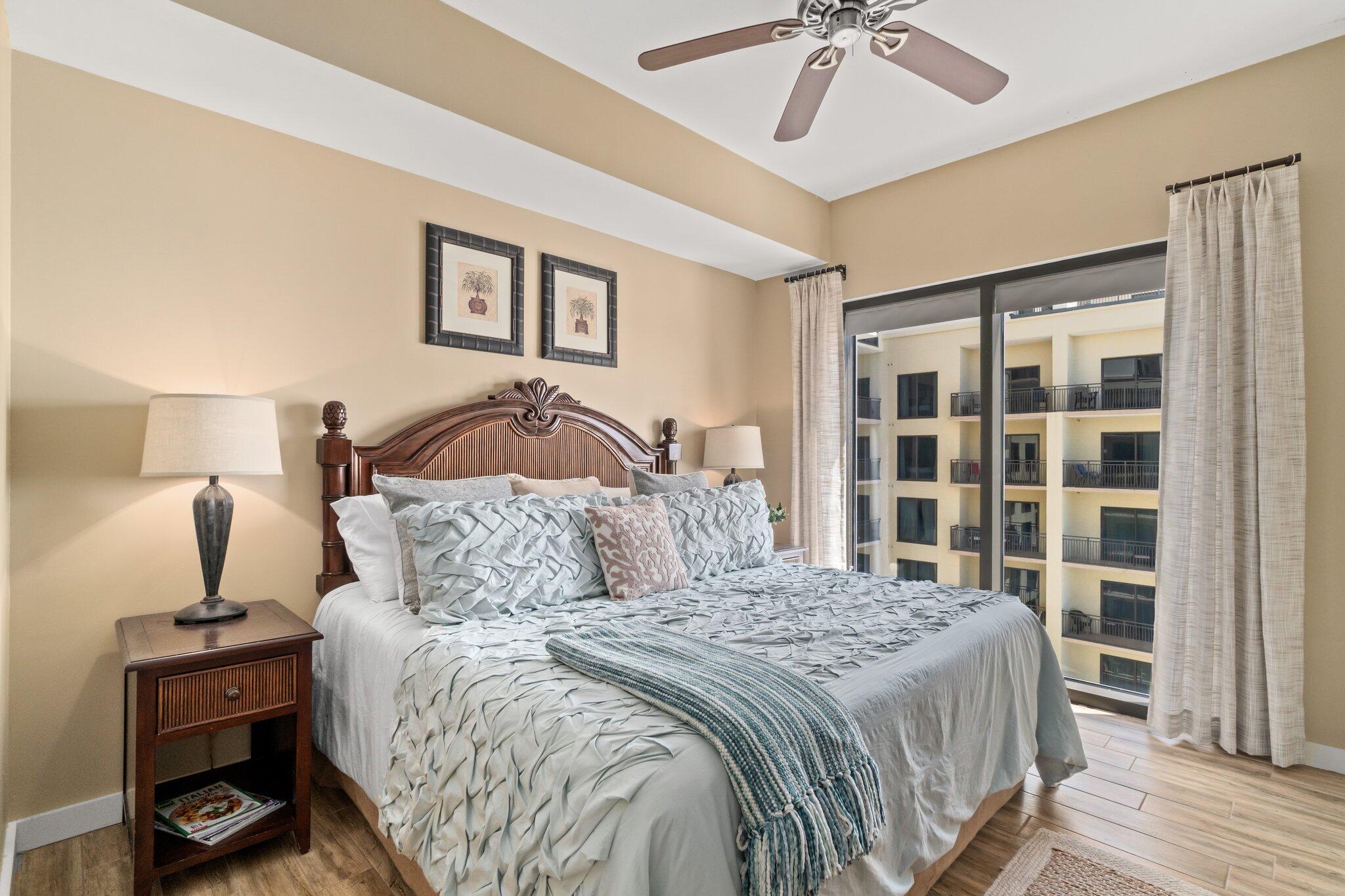 15100 Front Beach Road, Unit 1302 Panama City Beach, FL 32413 - Photo 33 of 67 a bedroom with a bed and a chandelier