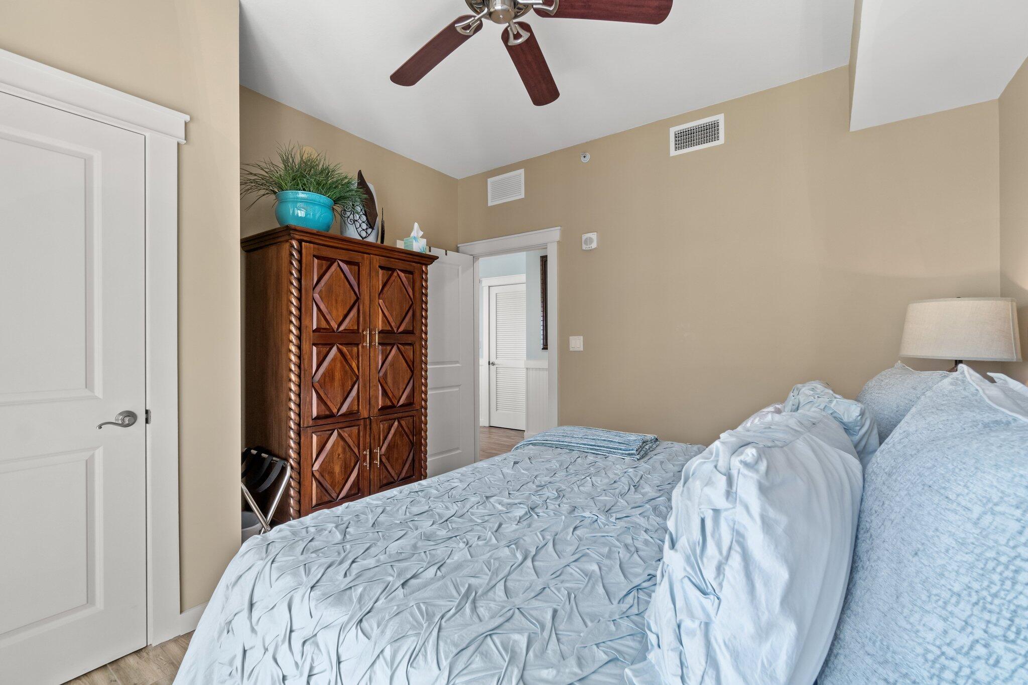 15100 Front Beach Road, Unit 1302 Panama City Beach, FL 32413 - Photo 35 of 67 a bedroom with a bed and a chandelier