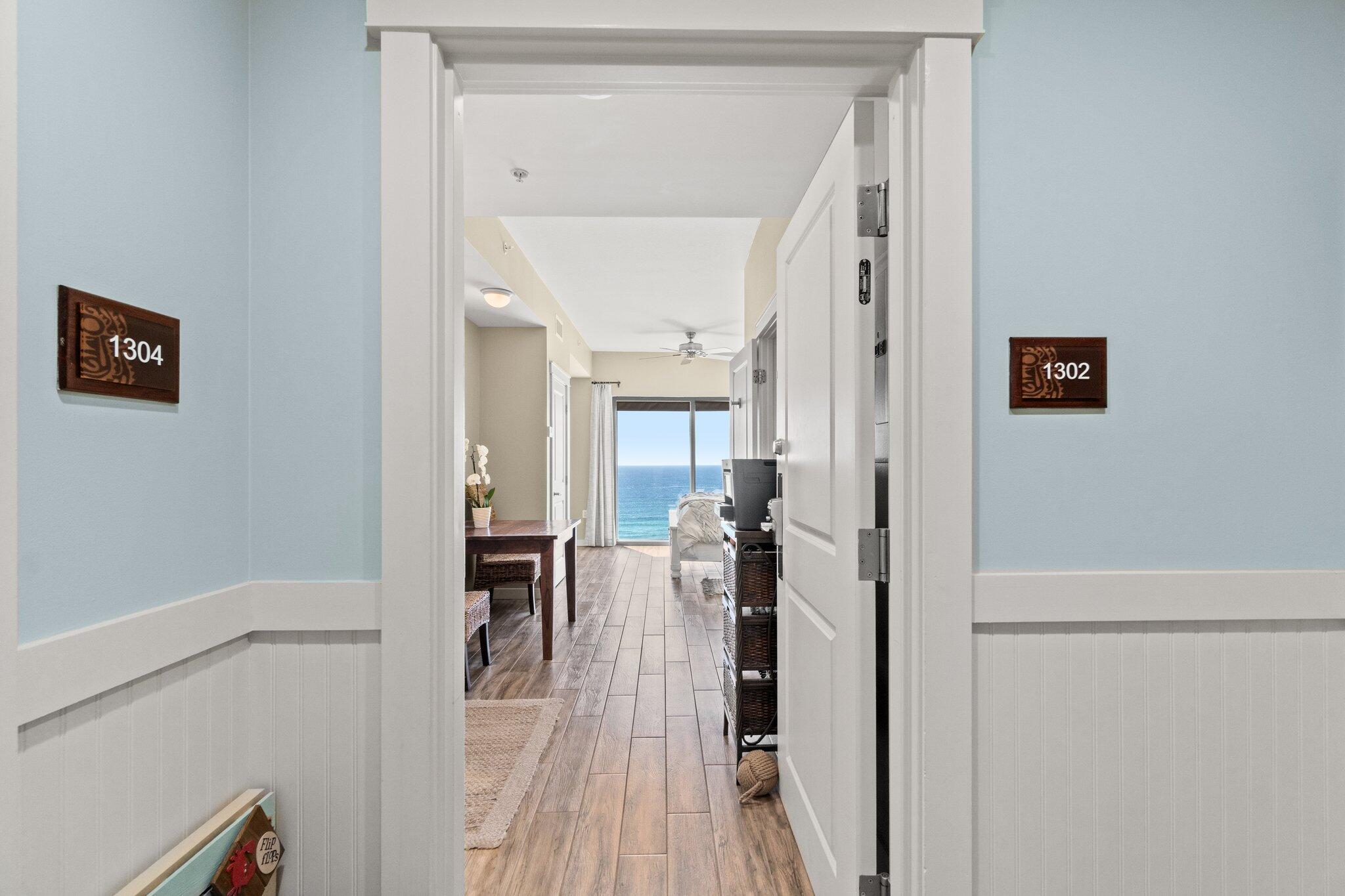 15100 Front Beach Road, Unit 1302 Panama City Beach, FL 32413 - Photo 36 of 67 a view of a hallway with a wooden floors