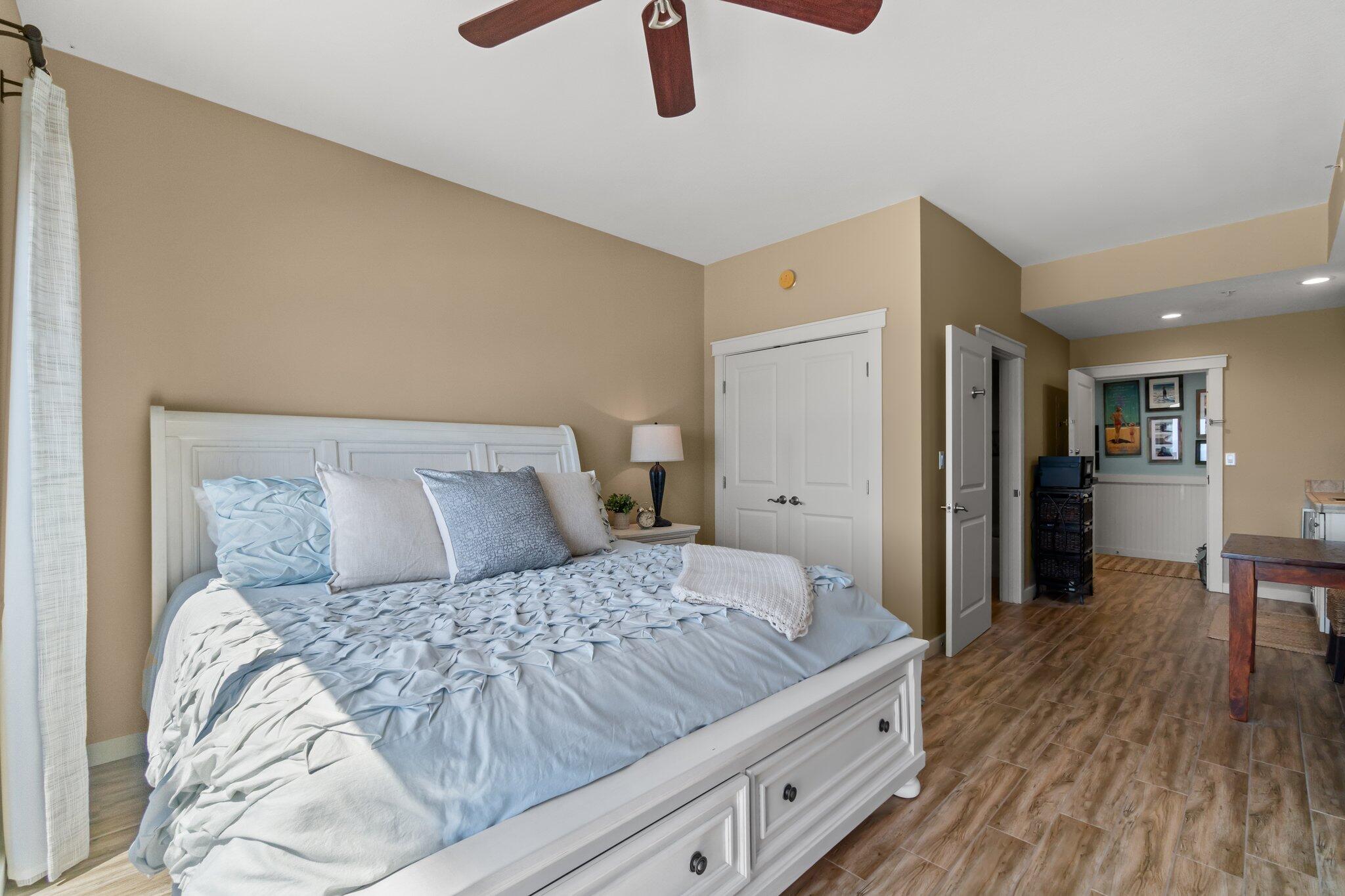 15100 Front Beach Road, Unit 1302 Panama City Beach, FL 32413 - Photo 42 of 67 a bedroom with a large bed and a chandelier