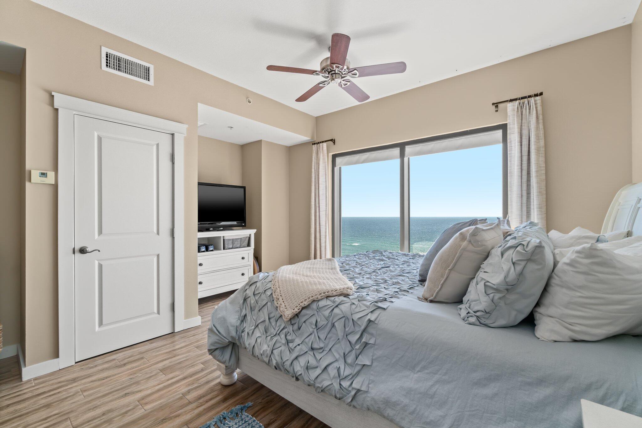 15100 Front Beach Road, Unit 1302 Panama City Beach, FL 32413 - Photo 44 of 67 a bedroom with a bed and a flat screen tv