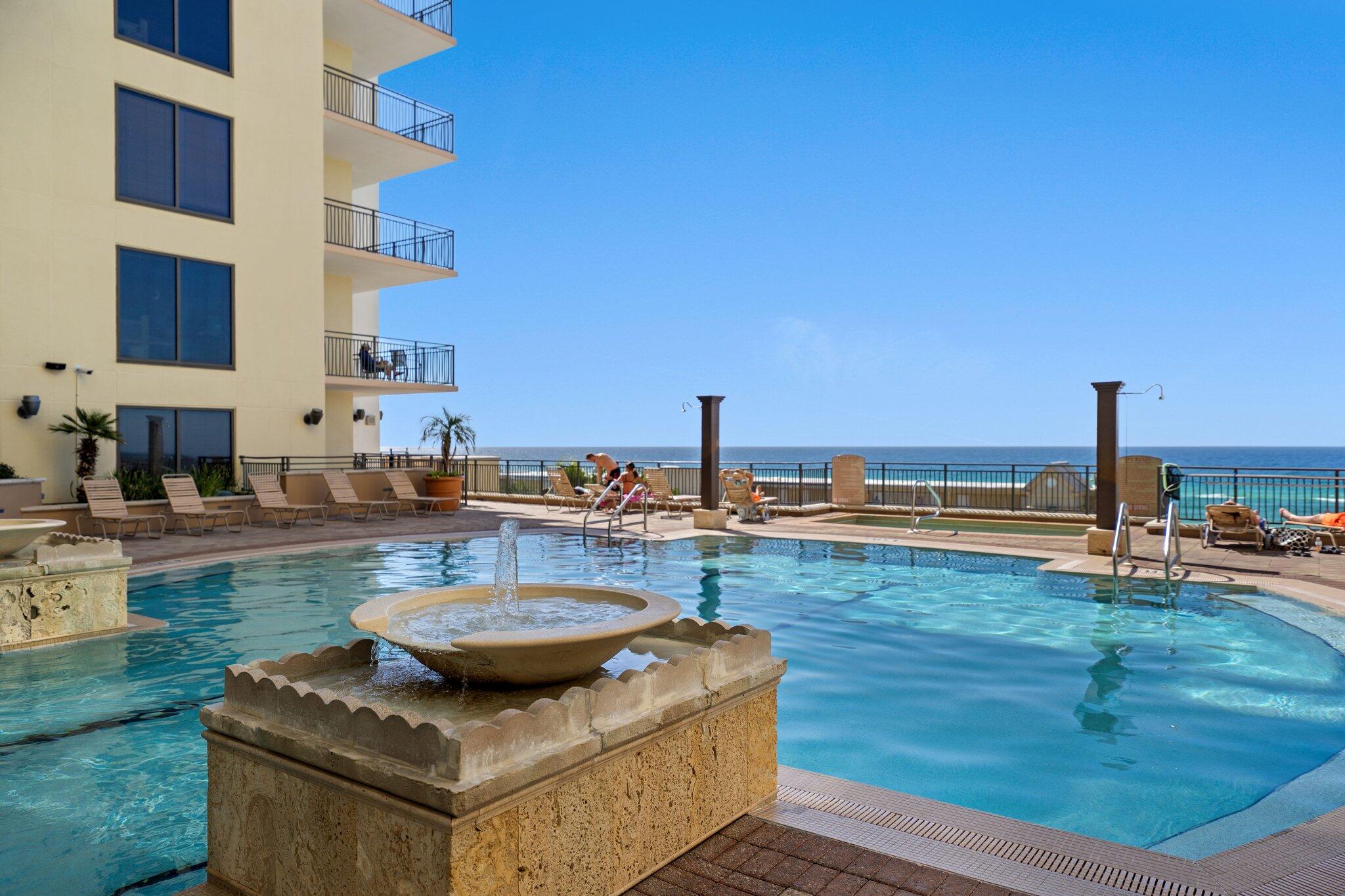 15100 Front Beach Road, Unit 1302 Panama City Beach, FL 32413 - Photo 53 of 67 a view of a patio with dining table and chairs with wooden floor and ocean view