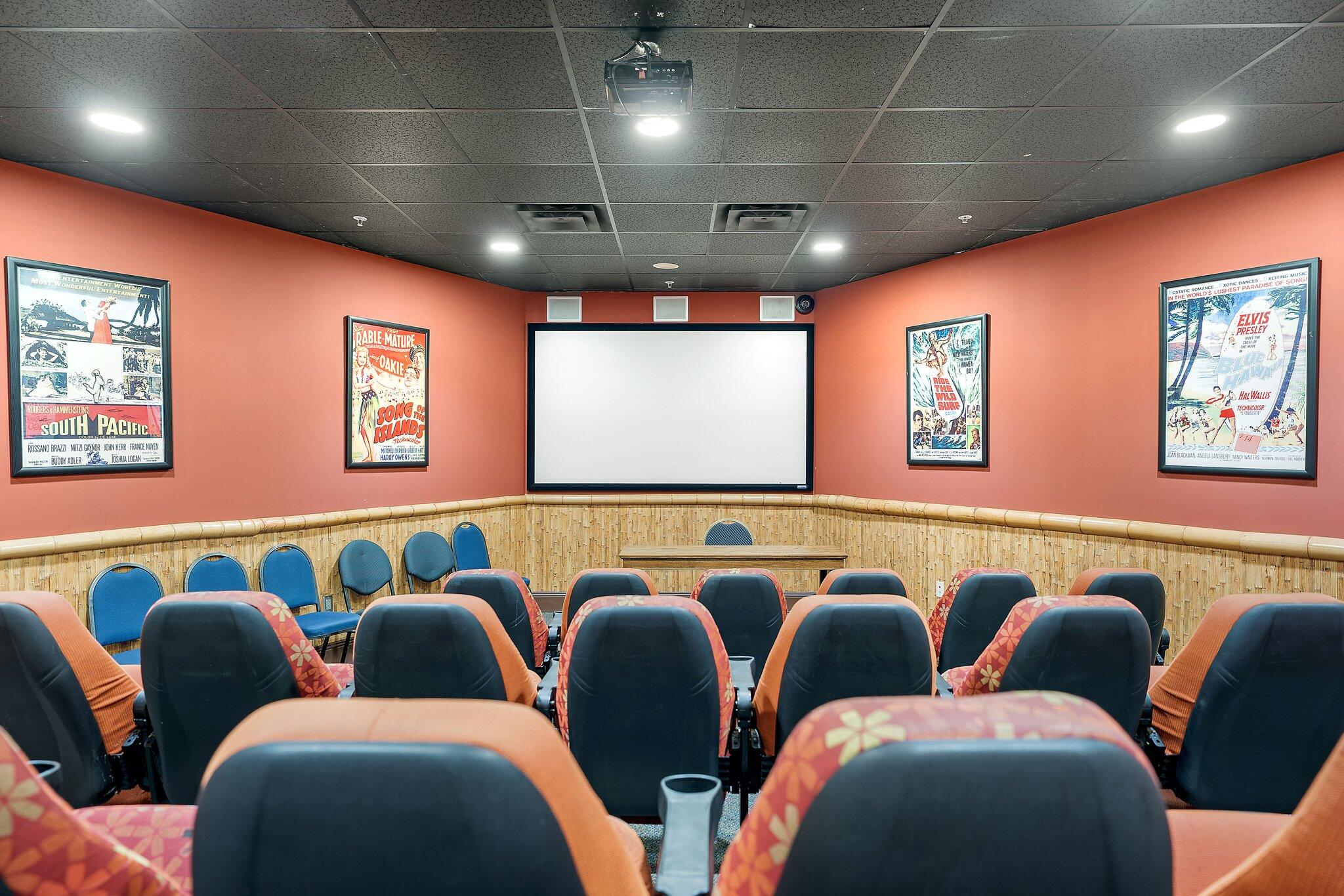 15100 Front Beach Road, Unit 1302 Panama City Beach, FL 32413 - Photo 56 of 67 a group of blue chairs sitting in a room next to a projector with a kitchen