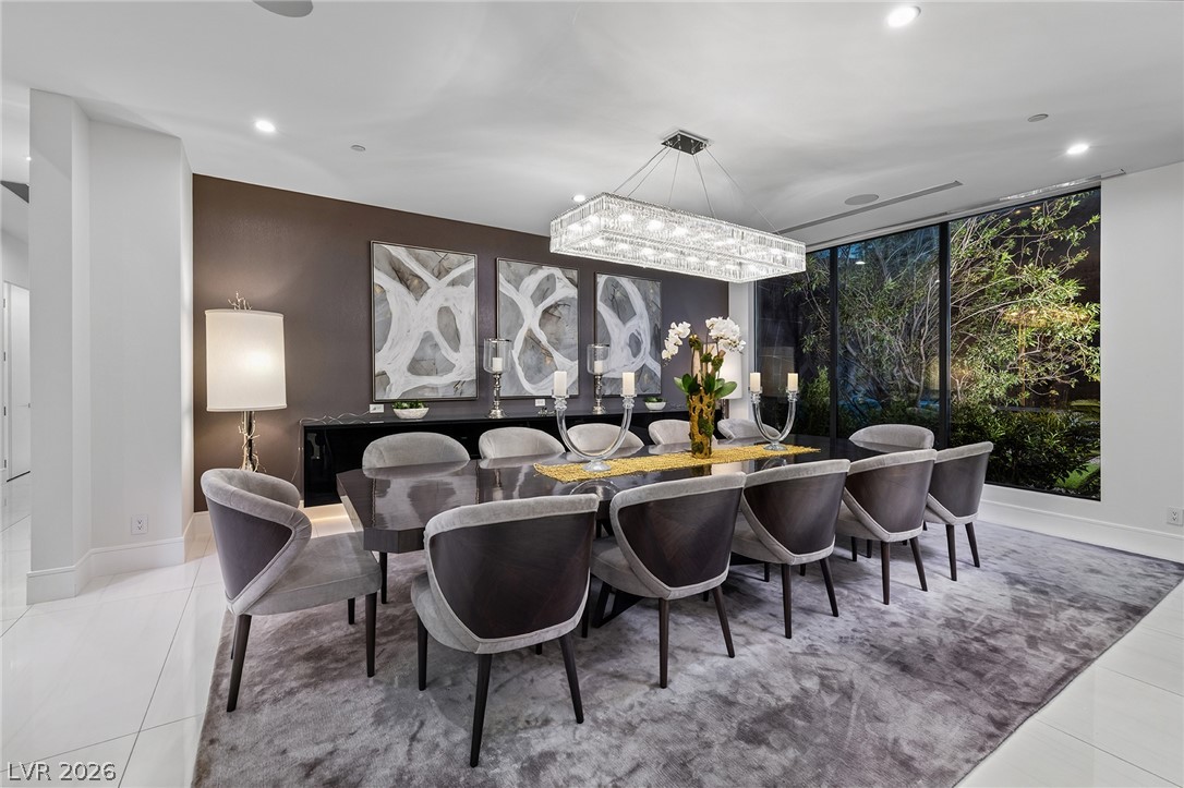 611 Cityview Ridge Drive Henderson, NV 89012 - Photo 27 of 66 Floor-to-ceiling glass walls frame serene backyard greenery from this sophisticated dining area.