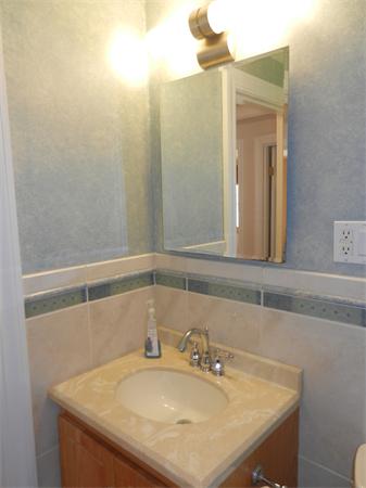 18 Arnold Road Peabody, MA 01960 - Photo 14 of 16 a bathroom with a sink and a mirror