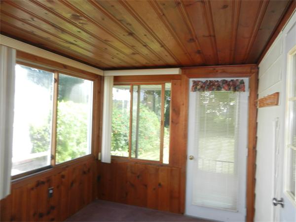 18 Arnold Road Peabody, MA 01960 - Photo 8 of 16 a big room with wooden floor and doors