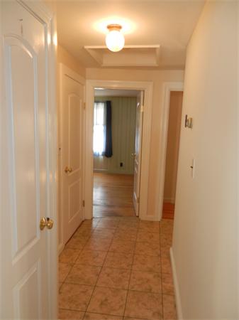 18 Arnold Road Peabody, MA 01960 - Photo 9 of 16 a view of a hallway with wooden shelves