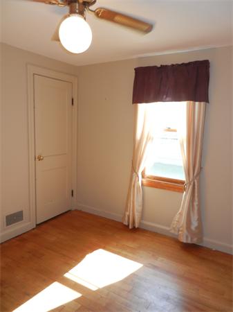 18 Arnold Road Peabody, MA 01960 - Photo 10 of 16 an empty room with wooden floor and windows