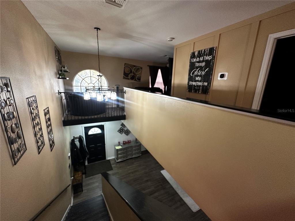 15040 Southwest 39th Circle Ocala, FL 34473 - Photo 11 of 23 a view of a hallway with couches and chandelier