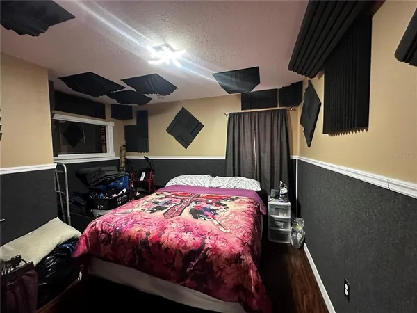 a bed sitting in a bedroom next to a window