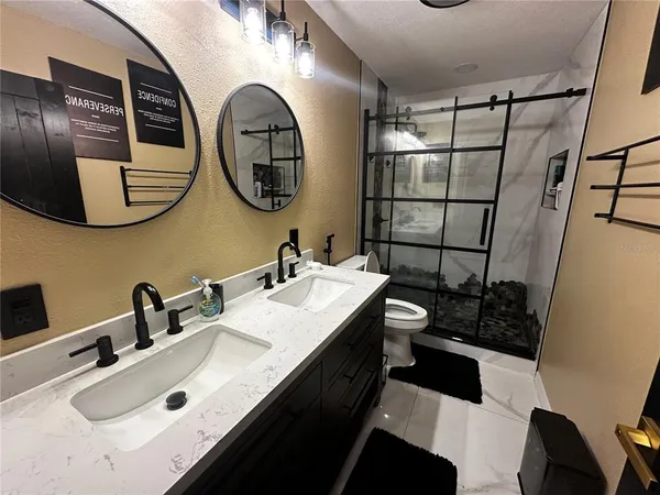 a bathroom with a double vanity sink and a mirror