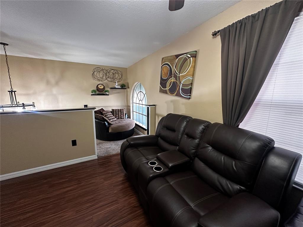 15040 Southwest 39th Circle Ocala, FL 34473 - Photo 16 of 23 a living room with furniture and wooden floor