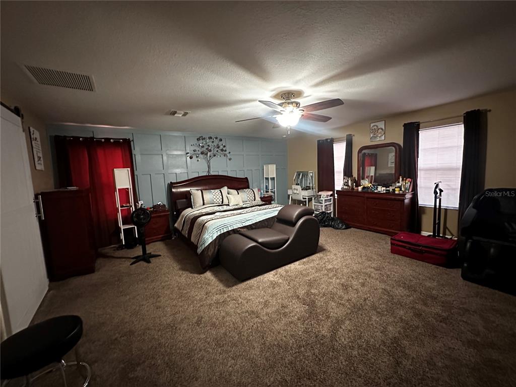 15040 Southwest 39th Circle Ocala, FL 34473 - Photo 18 of 23 a bedroom with a bed a couch and dresser