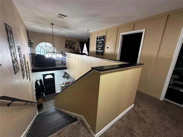 a view of a living room with furniture and a flat screen tv