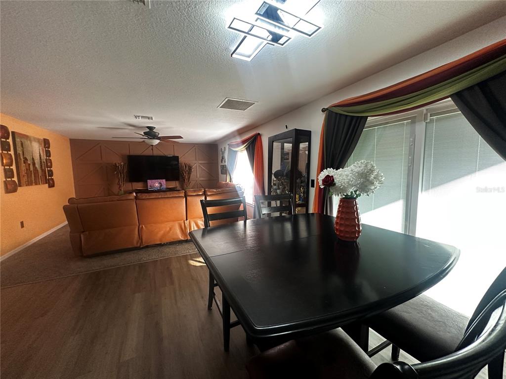 15040 Southwest 39th Circle Ocala, FL 34473 - Photo 7 of 23 a view of a dining room with furniture and wooden floor