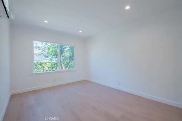 an empty room with windows and entrance