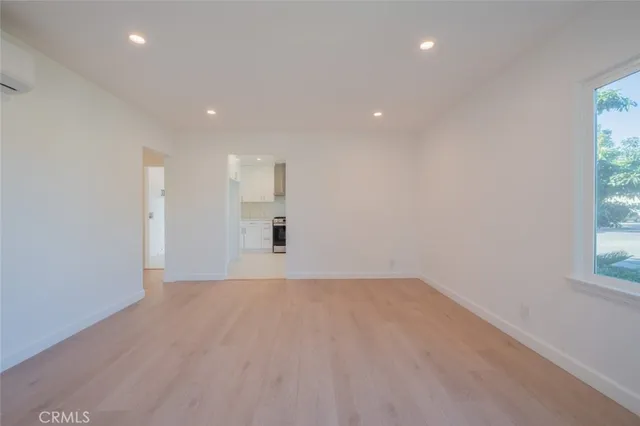 a kitchen with granite countertop white cabinets and stainless steel appliances