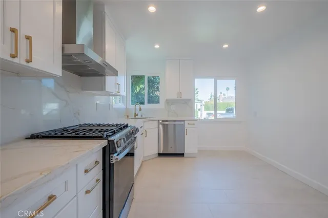 a kitchen with cabinets and stainless steel appliances
